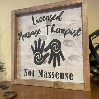 Framed sign reading Licensed Massage Therapist Not Masseuse displayed in Hands On Health studio