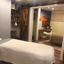 Wide angle view of Hands On Health studio showing hallway and treatment rooms with barn wood details