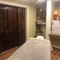 The Cedar Room — dark stained wood doors and treatment table